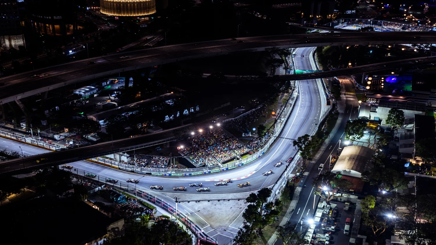 F1 cars speeding past Turn 5 of the Marina Bay Street Circuit